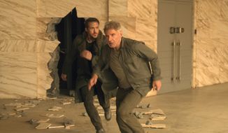 This image released by warner Bros. Pictures shows Ryan Gosling, left, and Harrison Ford in a scene from &quot;Blade Runner 2049.&quot; (Stephen Vaughan/Warner Bros. Pictures via AP)