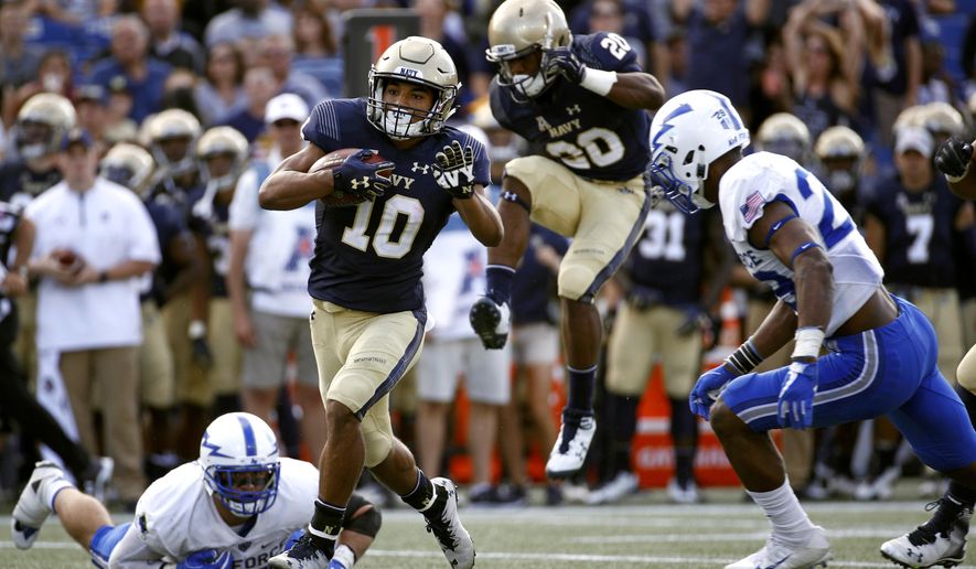 Navy running back Malcolm Perry (10) rushes past Air Force defenders in the first half of an NCAA college football game in Annapolis, Md., Saturday, Oct. 7, 2017. (AP Photo/Patrick Semansky)