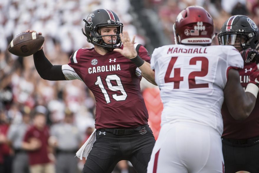 South Carolina quarterback Jake Bentley (19) throws a pass against Arkansas defensive lineman Jonathan Marshall (42) during the first half of an NCAA college football game on Saturday, Oct. 7, 2017, in Columbia, S.C. (AP Photo/Sean Rayford)