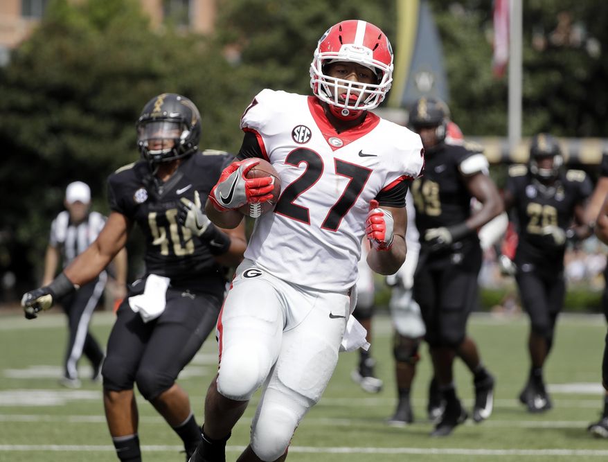 Georgia running back Nick Chubb (27) scores a touchdown against Vanderbilt on a 14-yard run in the first half of an NCAA college football game Saturday, Oct. 7, 2017, in Nashville, Tenn. (AP Photo/Mark Humphrey)
