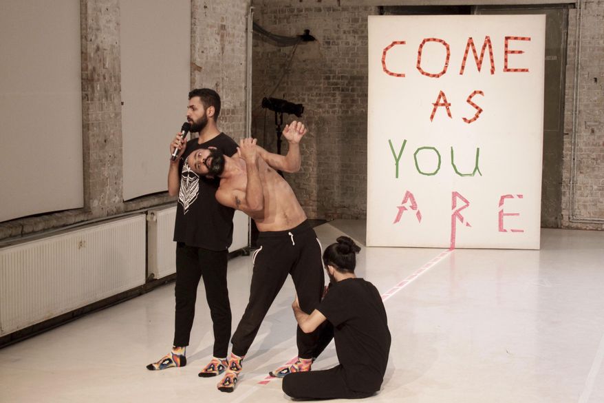 In this Sept. 5 photo, Syrian migrants Medhat Aldaabal, Moufak Aldoabl and Amr Karkout, practice ahead of a performance of "Come As You Are" in Berlin. The dance and theatre show deals with life as a migrant in the German capital. (AP Photo/Jona Kallgren)