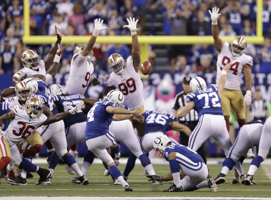 Indianapolis Colts' Adam Vinatieri (4) kicks a game winning 51-yard field goal out of the hold of Rigoberto Sanchez (2) during overtime of an NFL football game against the San Francisco 49ers, Sunday, Oct. 8, 2017, in Indianapolis. Indianapolis won 26-23. (AP Photo/Darron Cummings)