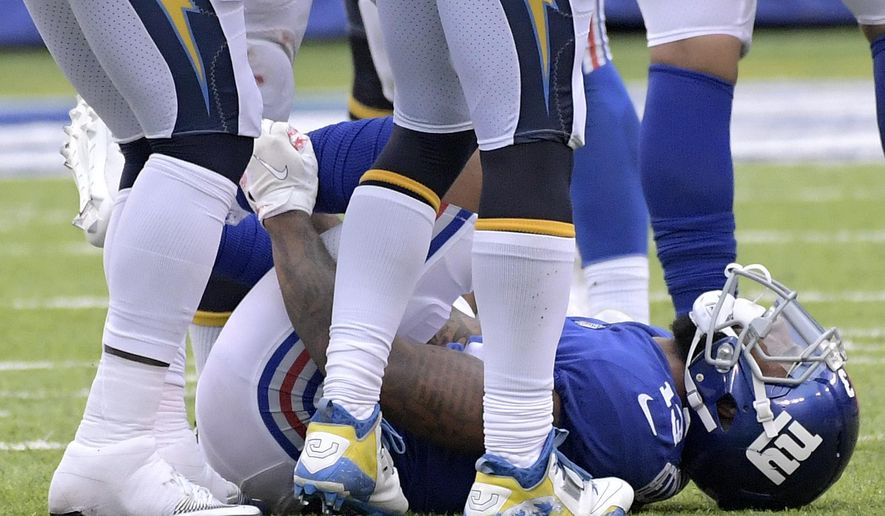 New York Giants wide receiver Odell Beckham grabs his leg after suffering an injury during the second half of an NFL football game against the Los Angeles Chargers, Sunday, Oct. 8, 2017, in East Rutherford, N.J. The Chargers won 27-22. (AP Photo/Bill Kostroun)
