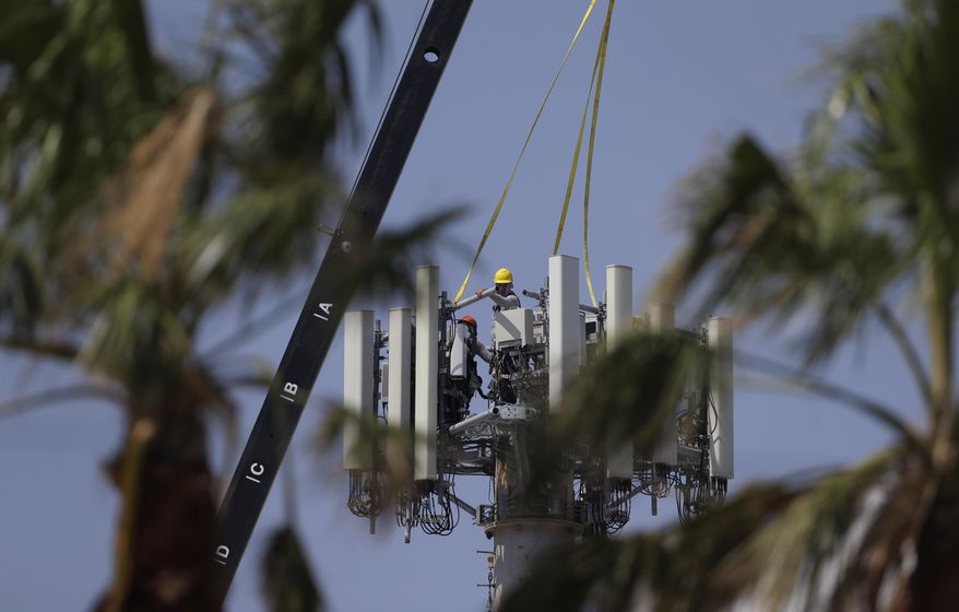 In this Friday, Sept. 29, 2017 photo, workers make repairs to a cell tower, in Port Aransas, Texas. (AP Photo/Eric Gay) **FILE**
