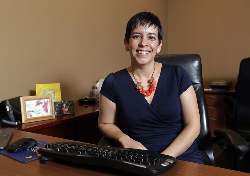In this Wednesday, Oct. 4, 2017, photo, health insurance broker Liz Gallops poses for a picture in a home office in Raleigh, N.C. Gallops, an independent broker who helps people buy coverage both on and off the Affordable Care Act’s public insurance marketplaces, can quickly list the obstacles that lie ahead in the upcoming enrollment window. (AP Photo/Gerry Broome)