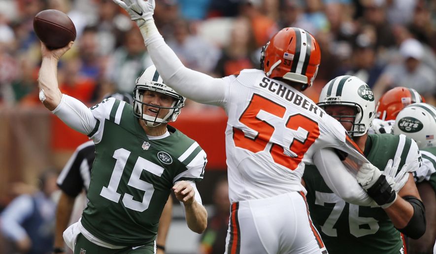 New York Jets quarterback Josh McCown (15) passes against Cleveland Browns outside linebacker Joe Schobert (53) during the first half of an NFL football game, Sunday, Oct. 8, 2017, in Cleveland. (AP Photo/Ron Schwane)