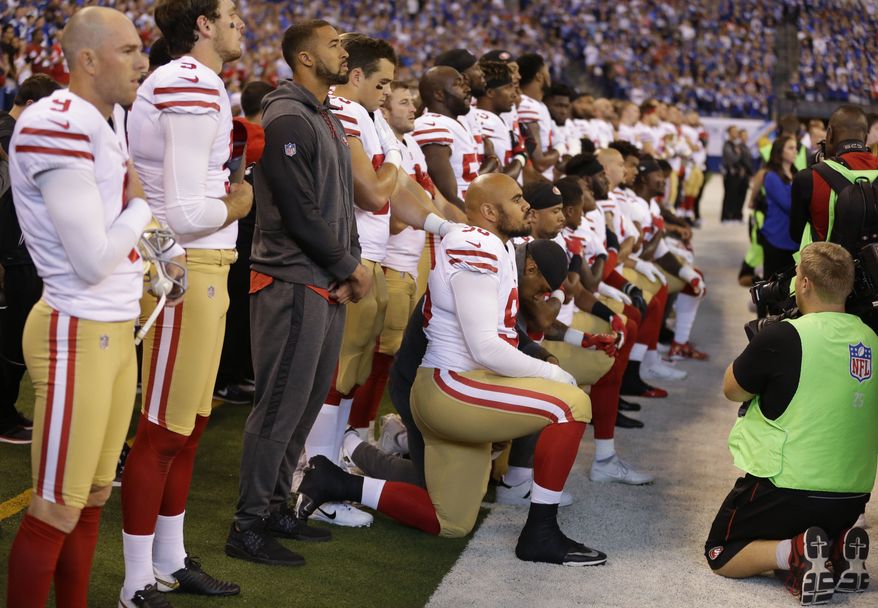 Members of the San Francisco 49ers kneel during the playing of the national anthem before an NFL football game against the Indianapolis Colts, Sunday, Oct. 8, 2017, in Indianapolis. Vice President Mike Pence left the 49ers-Colts game after about a dozen San Francisco players took a knee during the national anthem Sunday. (AP Photo/Michael Conroy)