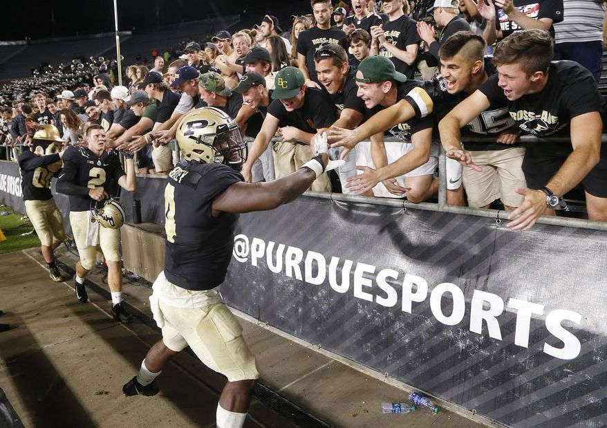Purdue's Ja'Whaun Bentley shakes hands with fans after the Purdue defeated Minnesota in an NCAA college football game, Saturday, Oct. 7, 2017, in West Lafayette, Ind. (John Terhune/Journal & Courier via AP)