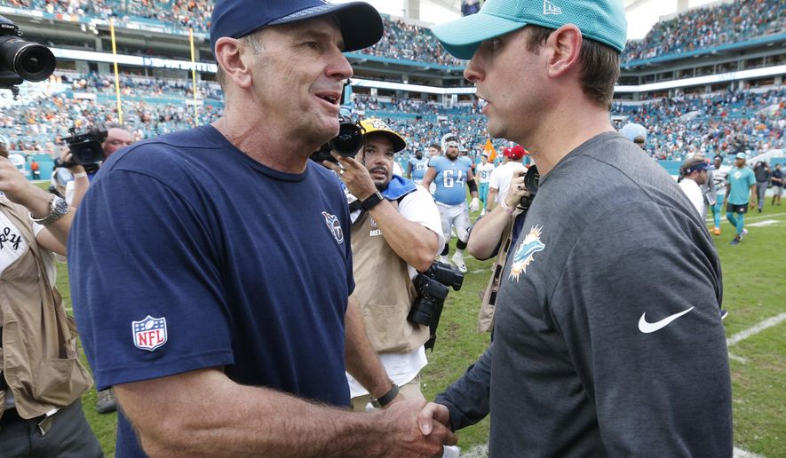 Tennessee Titans head coach Mike Mularkey, left, shakes the hand of Miami Dolphins head coach Adam Gase, at the end of an NFL football game, Sunday, Oct. 8, 2017, in Miami Gardens, Fla. The Dolphins defeated the Titans 16-10. (AP Photo/Wilfredo Lee)