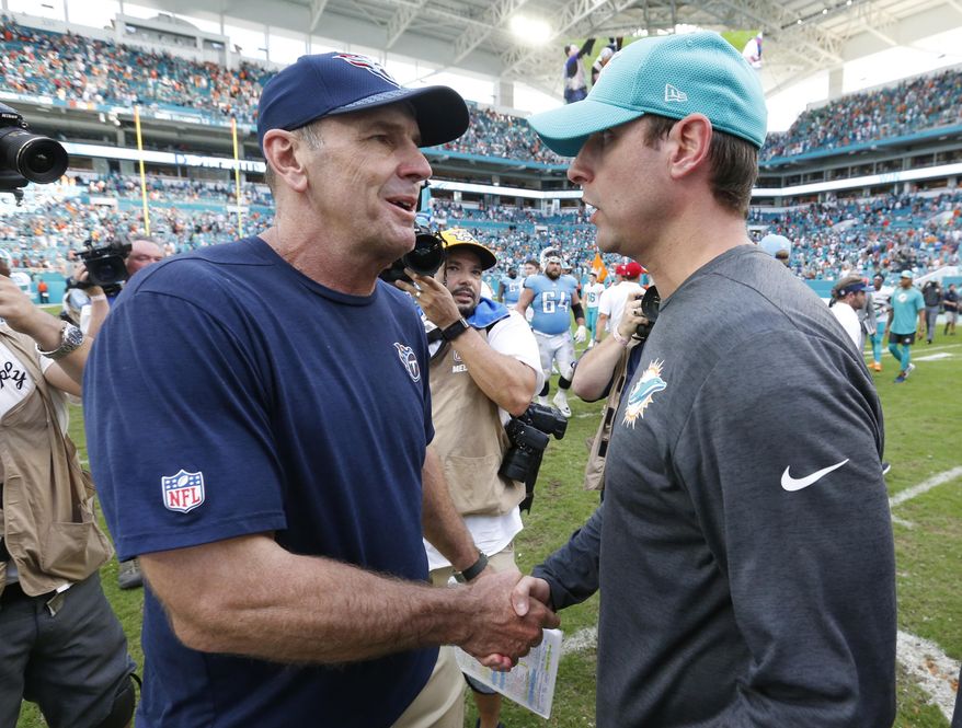 Tennessee Titans head coach Mike Mularkey, left, shakes the hand of Miami Dolphins head coach Adam Gase, at the end of an NFL football game, Sunday, Oct. 8, 2017, in Miami Gardens, Fla. The Dolphins defeated the Titans 16-10. (AP Photo/Wilfredo Lee)