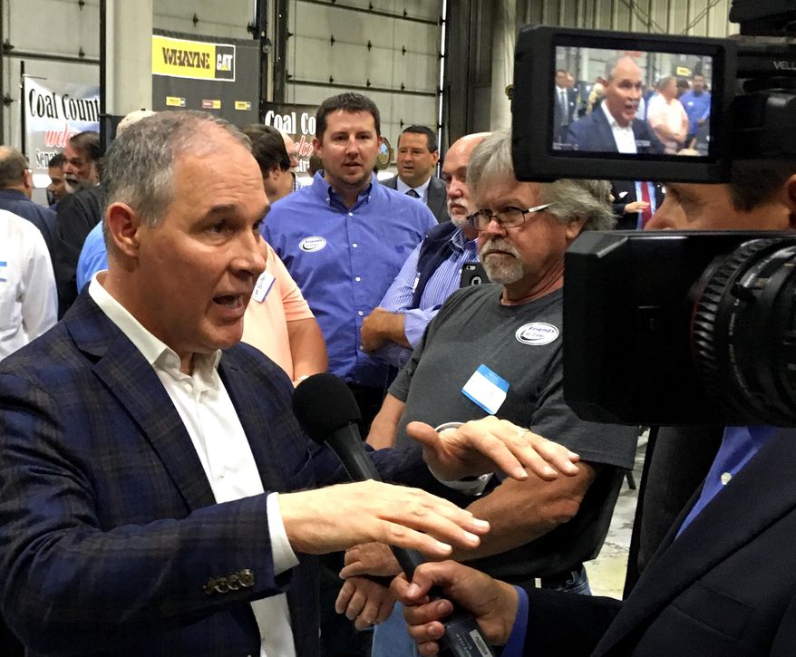 EPA Administrator Scott Pruitt, talks to a reporter after speaking at Whayne Supply in Hazard, Ky, Monday, Oct. 9, 2017.  Pruitt says the Trump administration will abandon the Obama-era clean power plan aimed at reducing global warming. (AP Photo/Adam Beam)