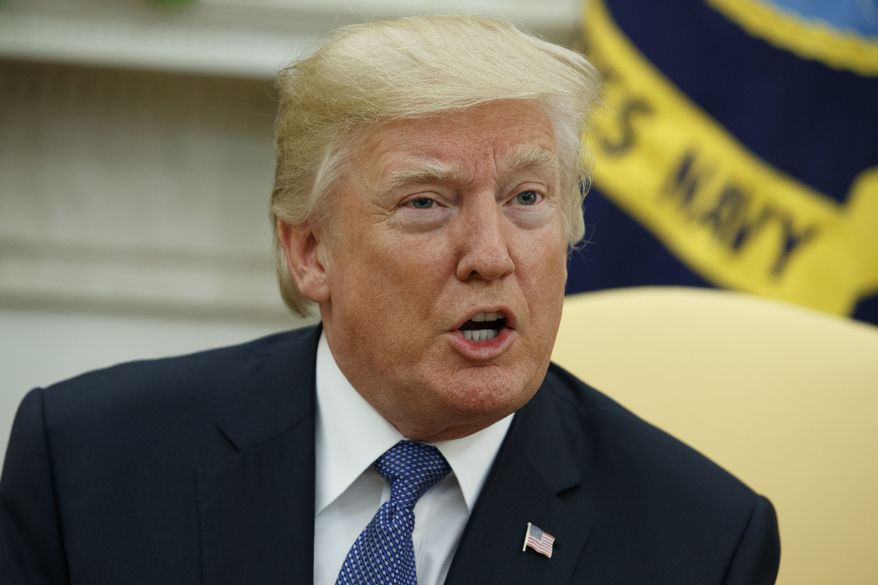 President Trump met Tuesday with former Secretary of State Henry Kissinger in the Oval Office. (Associated Press)