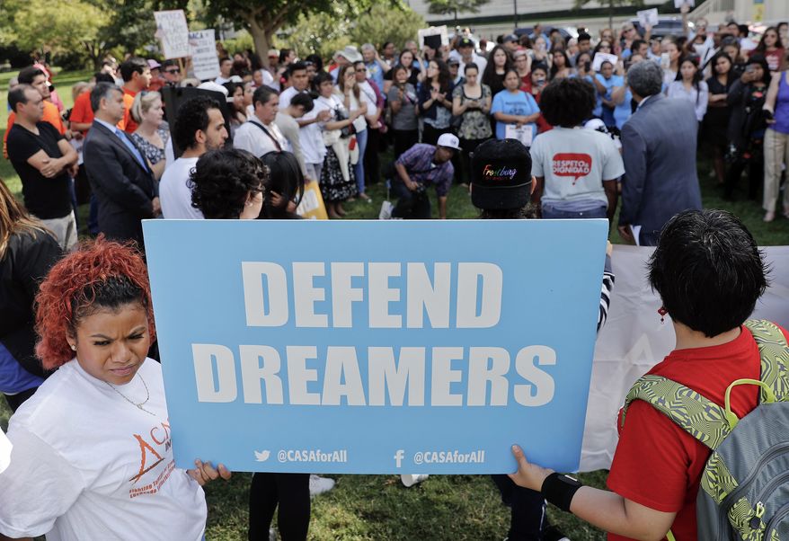 In this Sept. 26, 2017 photo, immigrant rights supporters gather at the U.S. Capitol in Washington. Just 1 in 5 Americans want to deport young immigrants brought to the United States illegally as children, a group now at the center of a politically fraught debate between the White House and Congress. Americans also have largely negative opinions about President Trump’s signature immigration pledge, according to a new poll by The Associated Press-NORC Center for Public Affairs Research. (AP Photo/Pablo Martinez Monsivais)