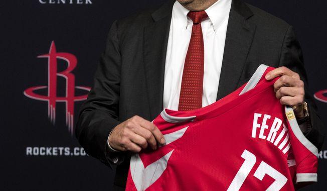 Houston Rockets owner Tilman Fertitta holds a jersey during an introductory news conference, Tuesday, Oct. 10, 2017, in Houston. (Brett Coomer/Houston Chronicle via AP)