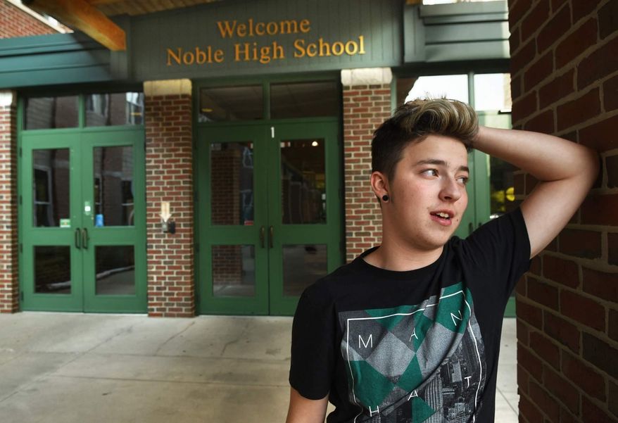 FILE - In this undated file photo, Stiles Zuschlag, a transgender teen, stands outside Noble High School in North Berwick, Maine. The Maine teen who was crowned homecoming king at his new school says he wants to use the attention to spread love and tolerance. (Deb Cram/Portsmouth Herald via AP, File)