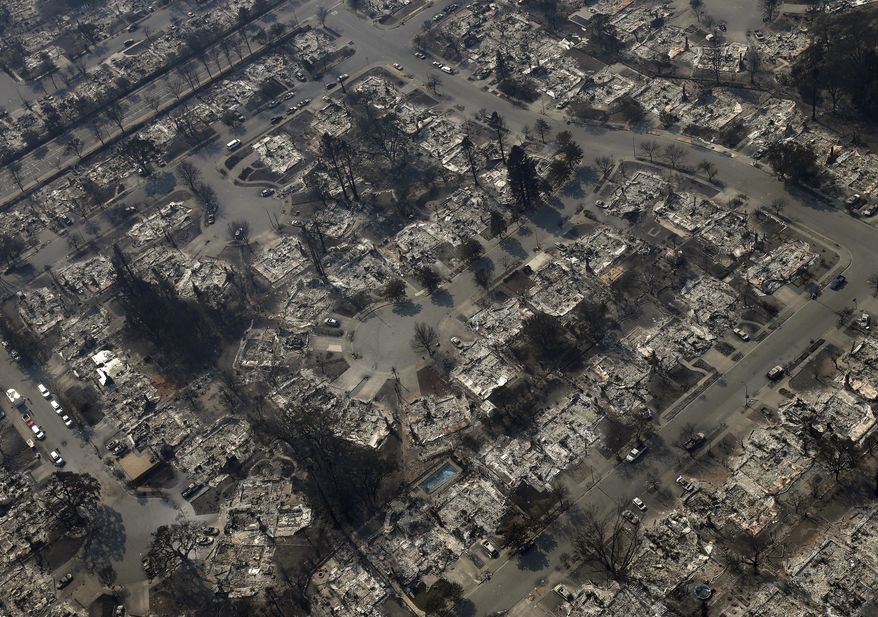 Burned out homes are seen in the Coffey Park area Wednesday, Oct. 11, 2017, in Santa Rosa, Calif. Wildfires whipped by powerful winds swept through Northern California sending residents on a headlong flight to safety through smoke and flames as homes burned. (AP Photo/Rich Pedroncelli)
