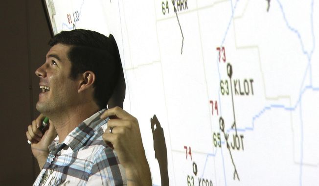 In this Sept. 14, 2017 photo, Northern Illinois University professor Victor Gensini teaches  students during a Geography 105 course titled "Weather Climate And You", at NIU in DeKalb, Ill. Less than a decade ago, Gensini was a student at NIU studying meterology. After earning a bachelor's degree in meteorology and a master's degree in geography at NIU, he earned his Ph.D. from the University of Georgia and taught at the College of DuPage for five years. Now, he is back at his alma mater to teach and research weather and climate. (Matthew Apgar /Daily Chronicle via AP)