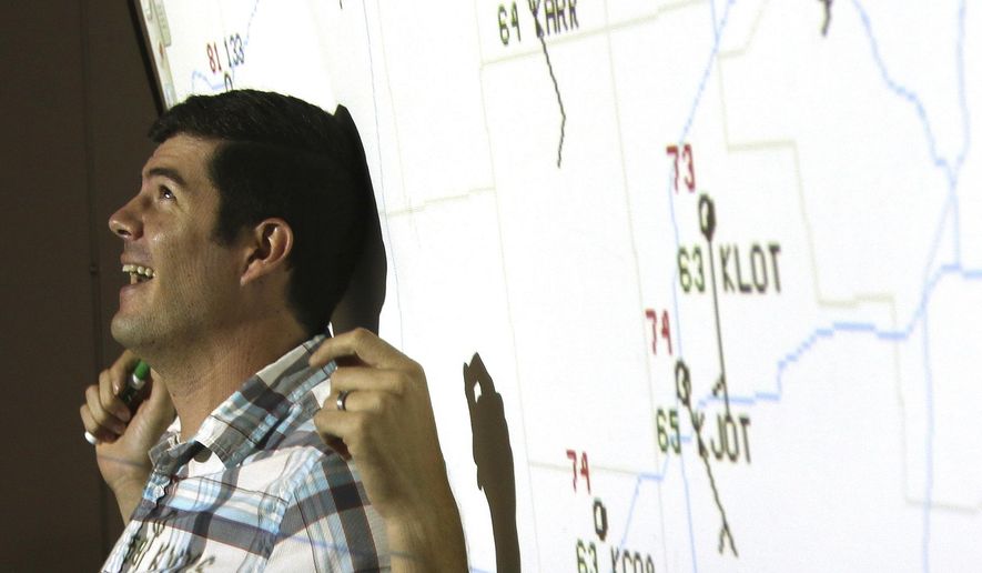 In this Sept. 14, 2017 photo, Northern Illinois University professor Victor Gensini teaches  students during a Geography 105 course titled "Weather Climate And You", at NIU in DeKalb, Ill. Less than a decade ago, Gensini was a student at NIU studying meterology. After earning a bachelor's degree in meteorology and a master's degree in geography at NIU, he earned his Ph.D. from the University of Georgia and taught at the College of DuPage for five years. Now, he is back at his alma mater to teach and research weather and climate. (Matthew Apgar /Daily Chronicle via AP)