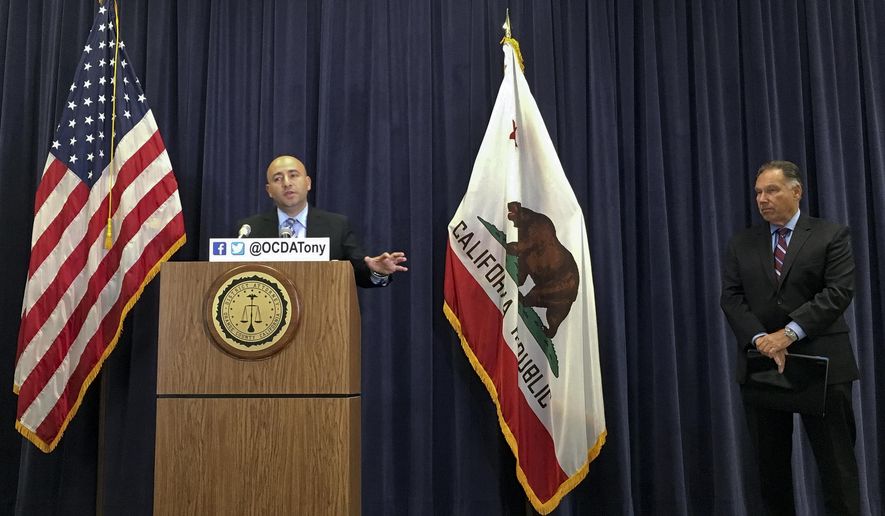 Assistant District Attorney Ebrahim Baytieh, left, speaks with reporters about the agency's conclusion that Orange Police were justified in shooting to death a 33-year-old man who reached for a knife after being forced to exit his locked van by a fire hose, at a news conference at the Orange County District Attorney's office in Santa Ana, Calif. District Attorney Tony Rackauckas, is seen right. (AP Photo/Amy Taxin)