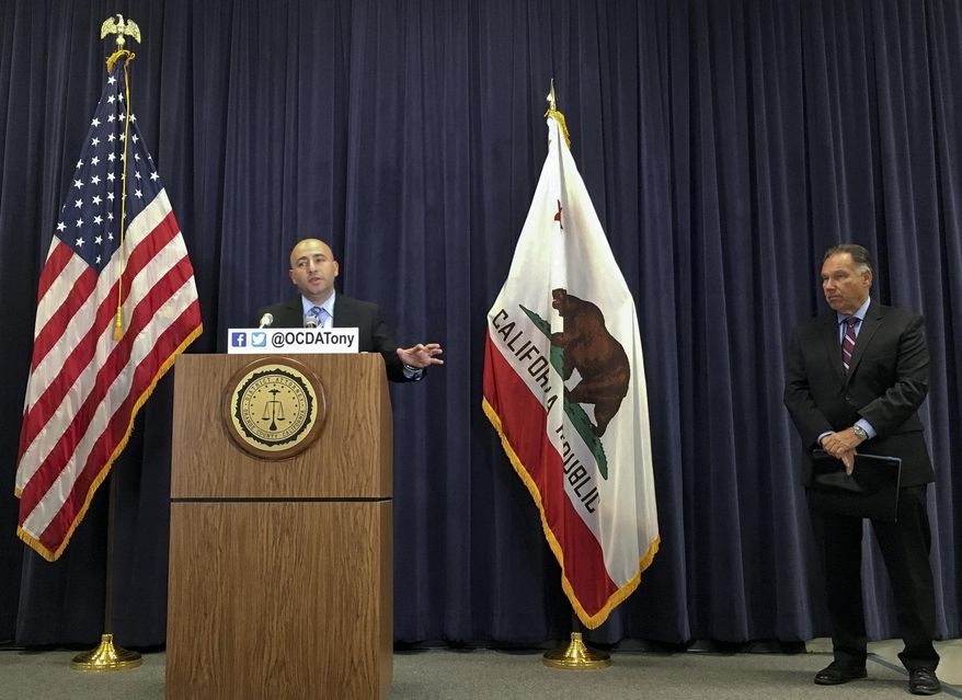 Assistant District Attorney Ebrahim Baytieh, left, speaks with reporters about the agency's conclusion that Orange Police were justified in shooting to death a 33-year-old man who reached for a knife after being forced to exit his locked van by a fire hose, at a news conference at the Orange County District Attorney's office in Santa Ana, Calif. District Attorney Tony Rackauckas, is seen right. (AP Photo/Amy Taxin)