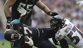 FILE - In this Sept. 24, 2017, file photo, Jacksonville Jaguars running back Leonard Fournette (27) is tackled by Baltimore Ravens inside linebacker C.J. Mosley (57) during the first half of an NFL football game at Wembley Stadium in London. As the man in the middle of the Ravens defense, 2014 first-round draft pick Mosley is the team&#x27;s leading tackler and already has seven career interceptions. (AP Photo/Matt Dunham, File)