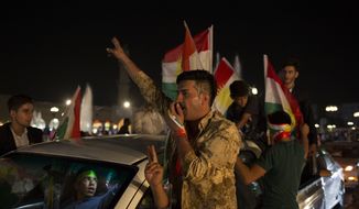 A man with &#39;yes&#39; shaved into his hair chants through a speaker in the streets of Irbil after polling stations closed on Monday, Sept. 25, 2017. The Kurds of Iraq were voting in a referendum on support for independence that has stirred fears of instability across the region, as the war against the Islamic State group winds down. (AP Photo/Bram Janssen)