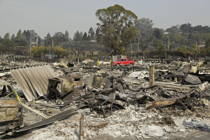 Shown are the remains of where Linda Tunis lived at the Journey's End mobile home park Wednesday, Oct. 11, 2017, in Santa Rosa, Calif. Jessica Tunis is searching for her missing mother, Linda Tunis, who was living at the mobile home park when the wildfires struck. (AP Photo/Eric Risberg)