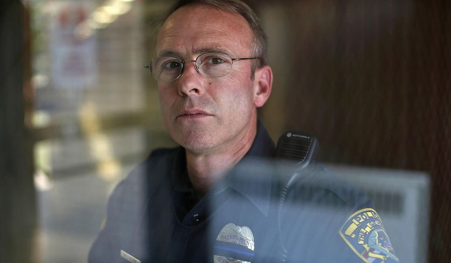 In this Sept. 13, 2017 photo, Baldwin school resource officer Bill Calkins poses for a photo at Baldwin School in Quincy, Ill. Calkins considers himself a bridge between the education system, the legal system and the community. (Jake Shane/The Quincy Herald-Whig via AP)