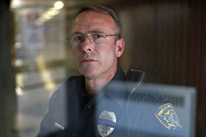 In this Sept. 13, 2017 photo, Baldwin school resource officer Bill Calkins poses for a photo at Baldwin School in Quincy, Ill. Calkins considers himself a bridge between the education system, the legal system and the community. (Jake Shane/The Quincy Herald-Whig via AP)