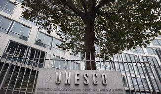 FILE - In this Monday Oct. 17, 2016 file picture, the United Nations Educational Scientific and Cultural Organization logo is pictured on the entrance at UNESCO&#39;s headquarters in Paris. U.S. officials have told The Associated Press that the United States is pulling out of UNESCO, after repeated criticism of resolutions by the U.N. cultural agency that Washington sees as anti-Israel. (AP Photo/Francois Mori, File)