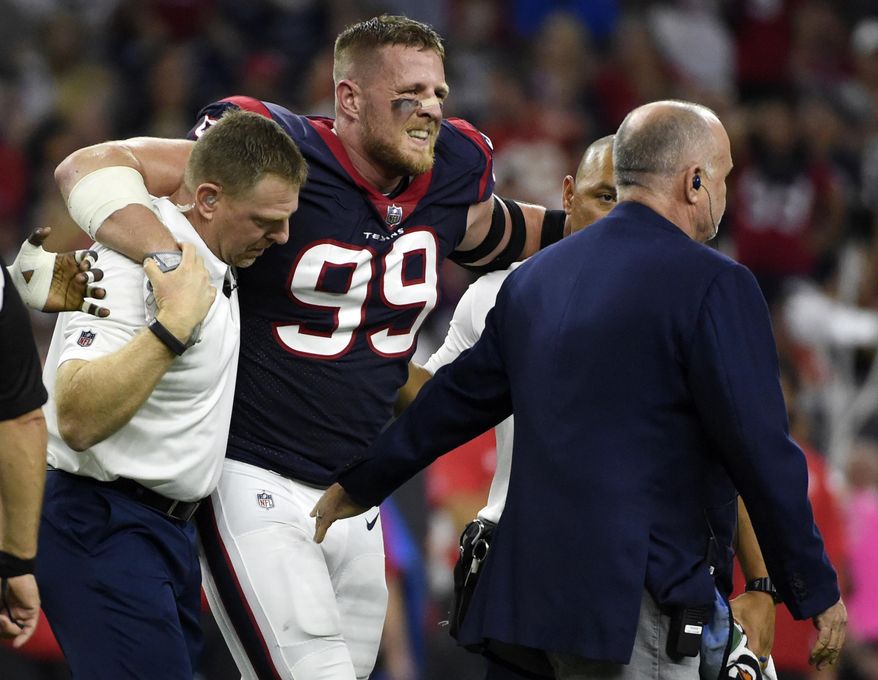 FILE - In this Oct. 7, 2017, file photo, Houston Texans defensive end J.J. Watt (99) is helped off the field after an injury during the first half of an NFL football game against the Kansas City Chiefs in Houston. (AP Photo/Eric Christian Smith, File)