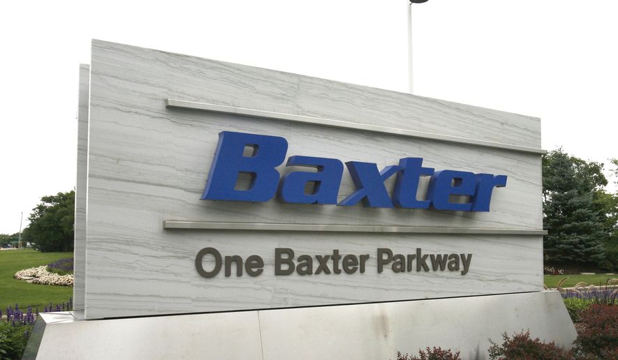 This July 2009 photo shows the sign outside Baxter International Inc. in Deerfield, Ill. Drug and medical product maker Baxter says it expects a near-term shortage of small bags of saline solution, widely used in hospitals to hydrate patients and mix with intravenous medicines, due to Hurricane Maria temporarily shutting down its operations in Puerto Rico. (George LeClaireDaily Herald via AP)