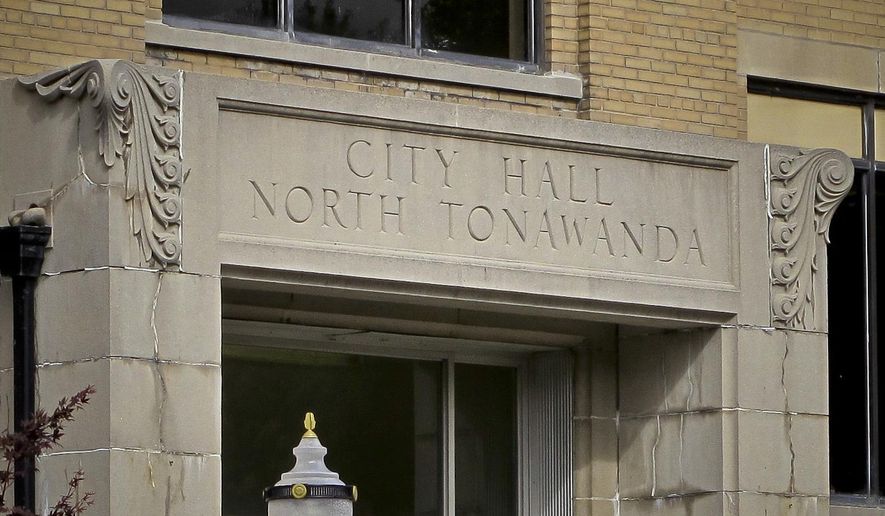 This photo shows signage above the entrance to North Tonawanda's City Hall where its city council resides, Thursday, Oct. 12, 2017, in New York. The council voted unanimously Oct. 3 to amend an existing law to add bullying, harassment and underage drinking to existing curfew violations parents already could be held accountable for. (AP Photo/Carolyn Thompson)
