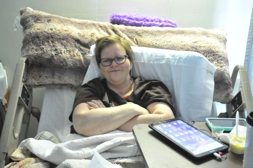In this Sept. 18, 2017, photo, Altera Moore poses for a photo at Parke View Rehabilitation and Care Center in Burley, Idaho. Nearly a year after Moore was critically injured when she was hit by a car as she walked in a rain storm, she continues to fight to regain her mobility and rebuild her life. (Laurie Welch/The Times-News via AP)