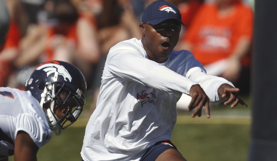 FILE - In this July 27, 2017, file photo, Denver Broncos defensive coordinator Joe Woods takes part in drills during an NFL football training camp, in Englewood, Colo. Denver's dominant defense had one fatal flaw last season. It was too predictable. Enter Joe Woods, who pledged upon succeeding his mentor, Wade Phillips, as defensive coordinator, to keep the foundation but "sprinkle a little sugar on it." (AP Photo/David Zalubowski, File)
