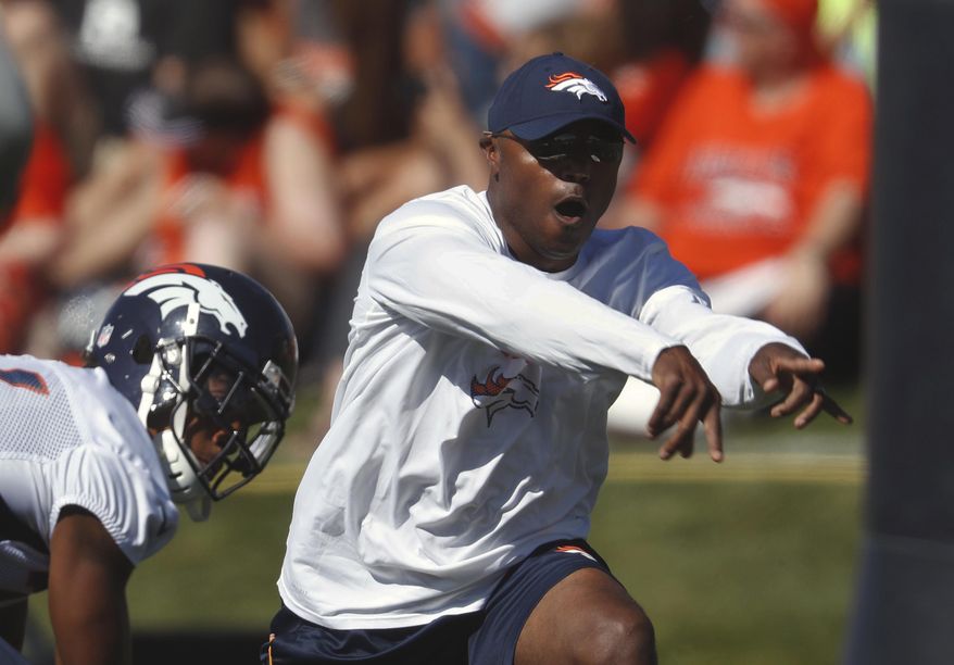 FILE - In this July 27, 2017, file photo, Denver Broncos defensive coordinator Joe Woods takes part in drills during an NFL football training camp, in Englewood, Colo. Denver's dominant defense had one fatal flaw last season. It was too predictable. Enter Joe Woods, who pledged upon succeeding his mentor, Wade Phillips, as defensive coordinator, to keep the foundation but "sprinkle a little sugar on it." (AP Photo/David Zalubowski, File)