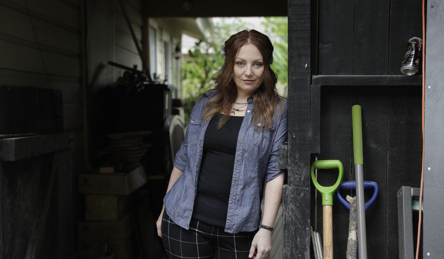FILE- In this May 23, 2017, file photo, Dawn Erin poses for a photo at her home, in Austin, Texas. Erin was among more than 20 million Americans who gained coverage under the Affordable Care Act. She went nearly two decades without insurance before Obamacare and is terrified to go back to a life of relying on sporadic charity care. President Donald Trump's decision to end a provision of the Affordable Care Act that lowered out-of-pocket medical costs brought swift reaction Friday, Oct. 13 from the states, as health officials and consumers said they feared the action could chase millions of Americans away from coverage.(AP Photo/Eric Gay, File)