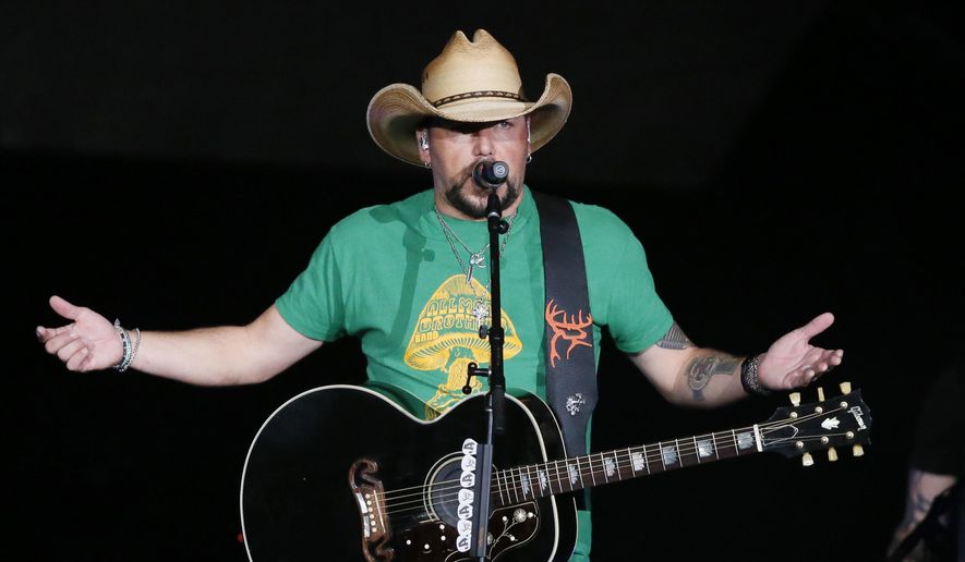 Jason Aldean addresses the crowd about the shooting in Las Vegas during his concert in Tulsa, Okla., Thursday, Oct. 12, 2017. The country star made an emotional return to the stage after cancelling tour dates following the deadliest mass shooting in modern U.S. history in Las Vegas. (AP Photo/Sue Ogrocki)