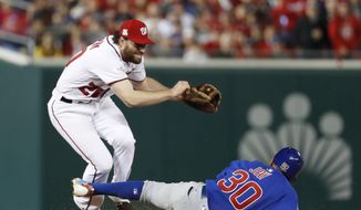 Washington Nationals second baseman Daniel Murphy (20) jumps after forcing out Chicago Cub&#39;s Jon Jay (30) on a ball hit by Kris Bryant, who was safe at first during seventh the inning of Game 5 of a baseball National League Division Series, at Nationals Park, Thursday, Oct. 12, 2017, in Washington. Kyle Schwarber scored on the play.  (AP Photo/Alex Brandon) **FILE**