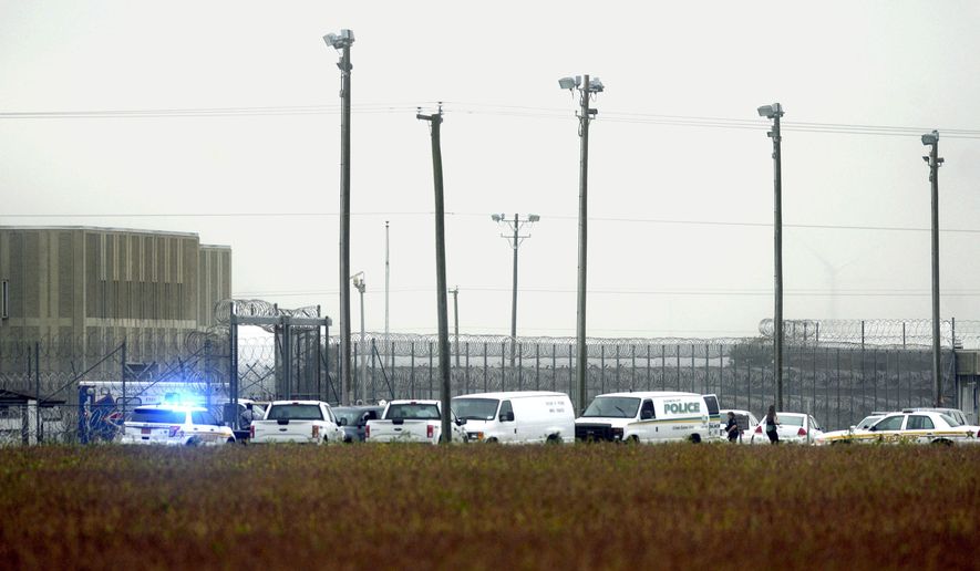 In this Thursday, Oct. 12, 2017 photo, police vehicles are seen outside Pasquotank Correctional Institution in Elizabeth City, N.C. Inmates at the North Carolina prison plotted an escape bid knowing they would have to hurt some prison employees, ultimately leaving two dead and a dozen other workers or fellow inmates injured, the investigating sheriff said Friday. (Thomas J. Turney /The Daily Advance via AP)