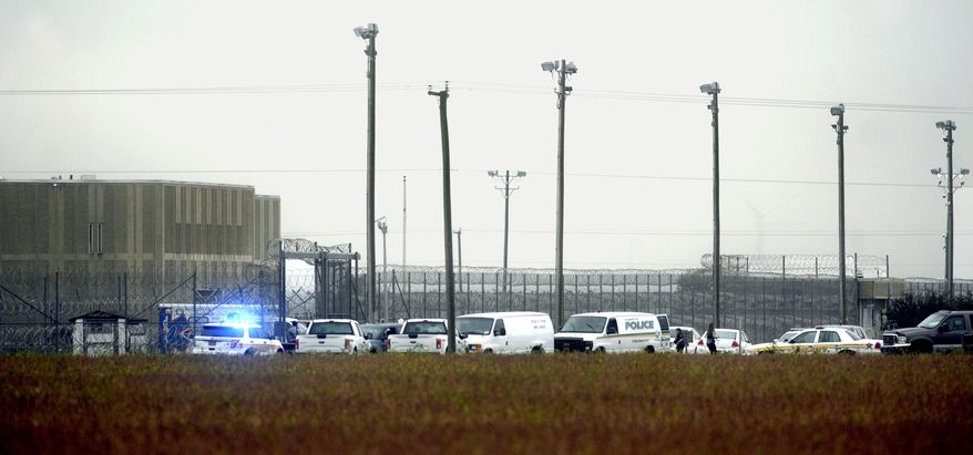 In this Thursday, Oct. 12, 2017 photo, police vehicles are seen outside Pasquotank Correctional Institution in Elizabeth City, N.C. Inmates at the North Carolina prison plotted an escape bid knowing they would have to hurt some prison employees, ultimately leaving two dead and a dozen other workers or fellow inmates injured, the investigating sheriff said Friday. (Thomas J. Turney /The Daily Advance via AP)