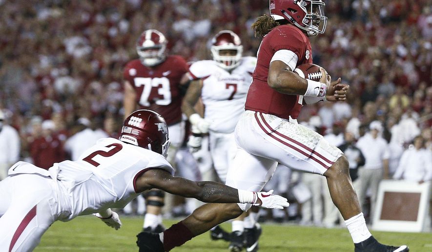 Alabama quarterback Jalen Hurts runs in for a touchdown as Arkansas defensive back Kamren Curl reaches for him during the first half an NCAA college football game Saturday, Oct. 14, 2017, in Tuscaloosa, Ala. (AP Photo/Brynn Anderson)