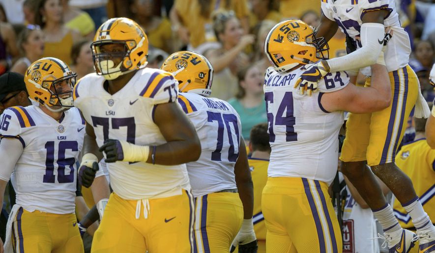 LSU wide receiver Russell Gage (83) celebrates a touchdown pass from quarterback Danny Etling (16) in the first half of an NCAA college football game against Auburn in Baton Rouge, La., Saturday, Oct. 14, 2017. (AP Photo/Matthew Hinton)