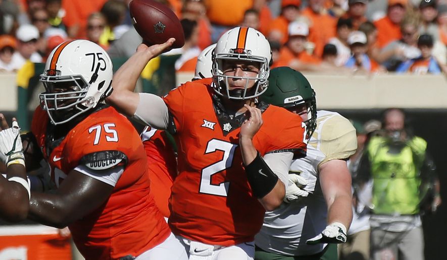 Oklahoma State quarterback Mason Rudolph (2) passes in the second quarter of an NCAA college football game against Baylor in Stillwater, Okla., Saturday, Oct. 14, 2017. (AP Photo/Sue Ogrocki)