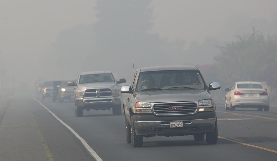 Smoke from a massive wildfire blanket Highway 9 near Oakville, Calif., Firefighters continue to battle the blaze burning in the heart of California&#39;s wine country.(AP Photo/Rich Pedroncelli)