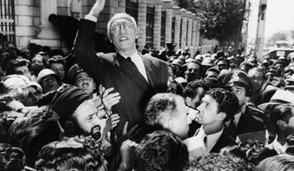 FILE- In this Sept. 27, 1951 file photo, Prime Minister Mohammed Mosaddegh rides on the shoulders of cheering crowds in Tehran&#39;s Majlis Square, outside the parliament building, after reiterating his oil nationalization views to his supporters. (AP Photo, File)
