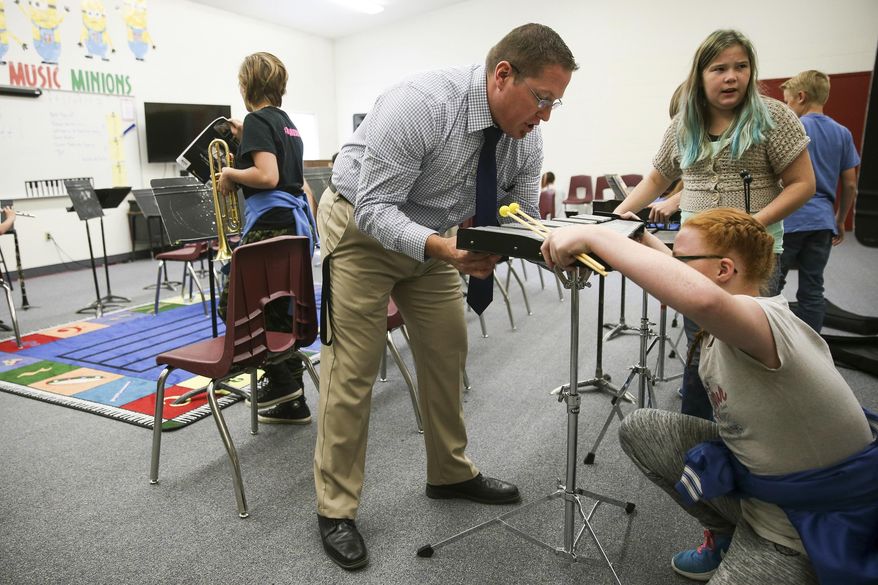 In this Thursday, Sept. 28, 2017 photo, Kodey Hughes, superintendent of the Tintic School District, teaches a music class at Eureka Elementary in Eureka, Utah. (Spenser Heaps/The Deseret News via AP)
