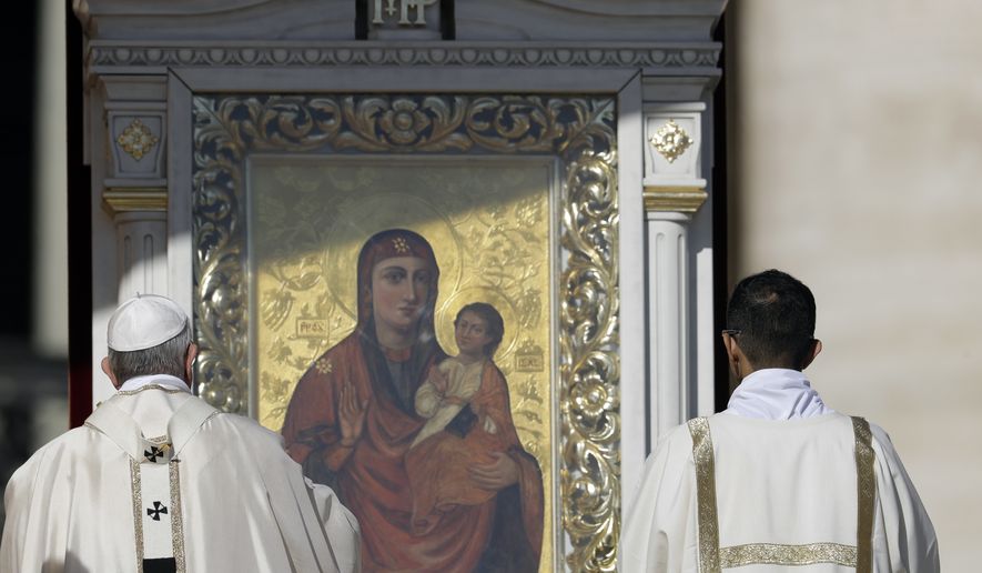 Pope Francis, left, asperges incense in front of an icon of Mary and baby Jesus as he celebrates a canonization mass for 35 new saints in St. Peter's Square at the Vatican, Sunday, Oct.15, 2017. (AP Photo/Andrew Medichini)