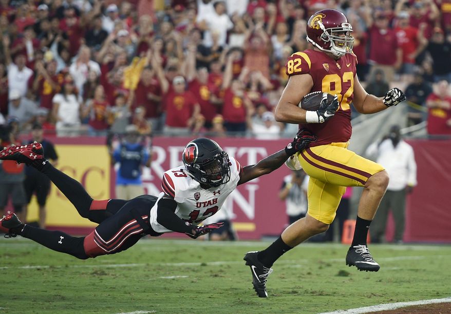 Southern California tight end Tyler Petite, right, runs in the ball after a catch for a touchdown ahead of Utah defensive back Marquise Blair during the first half of an NCAA college football game in Los Angeles, Saturday, Oct. 14, 2017. (AP Photo/Kelvin Kuo)