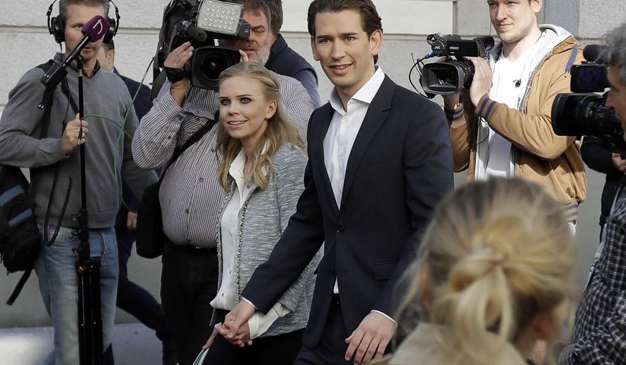 Foreign Minister Sebastian Kurz, head of Austrian People&#39;s Party, and his girlfriend Susanne Thier arrive to the polling station to casts their vote in Vienna, Austria, Sunday, Oct. 15, 2017, when about 6.4 million people are eligible to vote in the national elections. (AP Photo/Matthias Schrader)